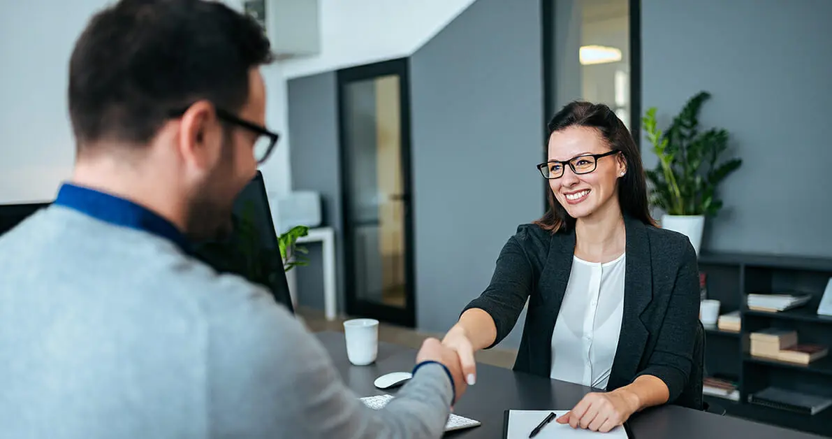 woman and man shaking hands for cannabis job interview