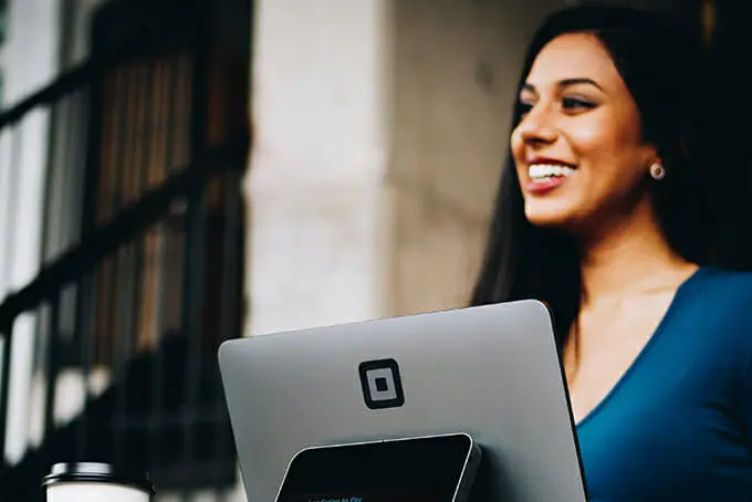 Woman smiling holding her laptop